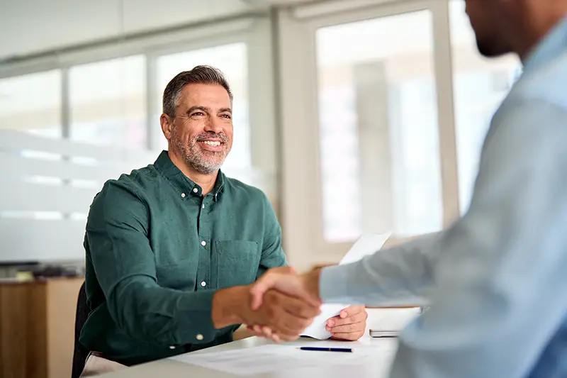 Smiling businessman conducting a meeting with a client