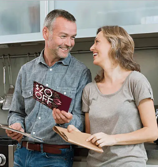 Couple smiling and reading the mail