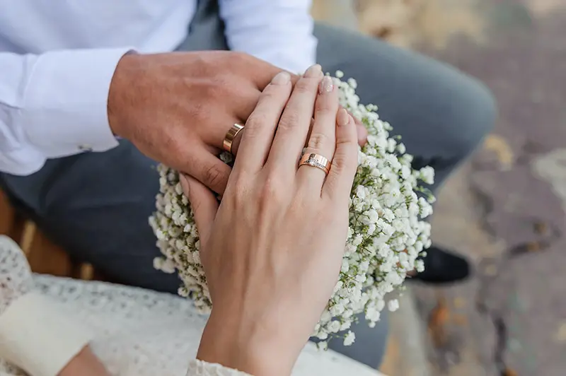 Newlyweds showing off their wedding bands